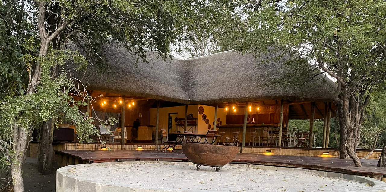 The camp pavilion lit warmly in the evening